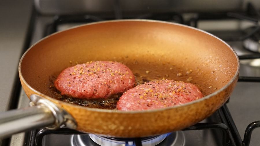 フライパンでハンバーグを焼いている様子のイメージ写真